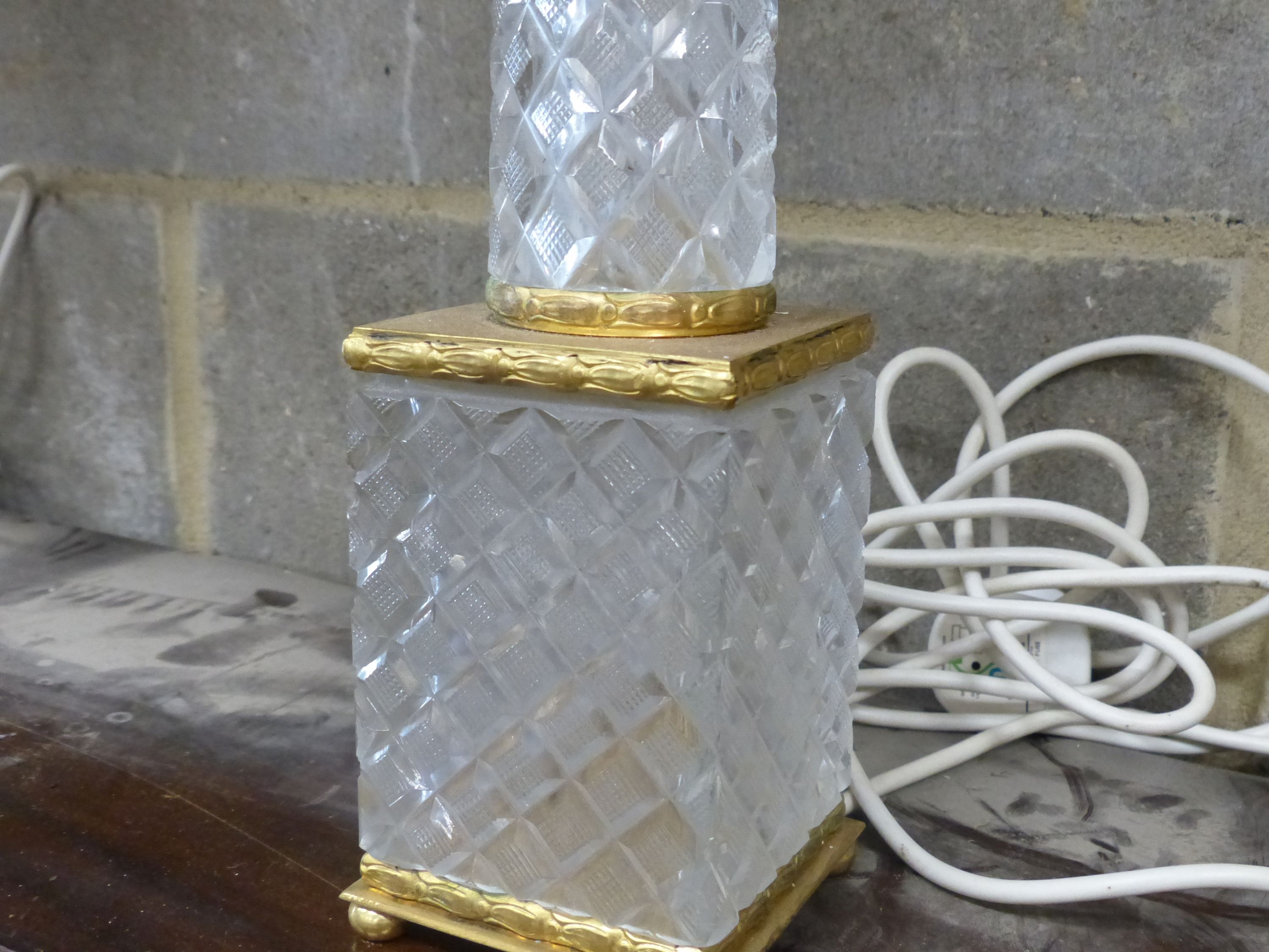 A pair of tall cut glass and gilt metal table lamps, having tapered columns and shades, height 50cm